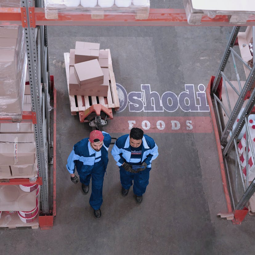 Two men walking at a warehouse